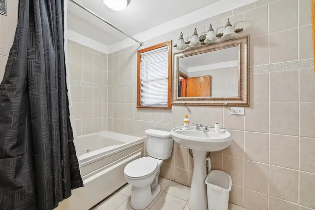 a bathroom with a sink mirror toilet and bathtub