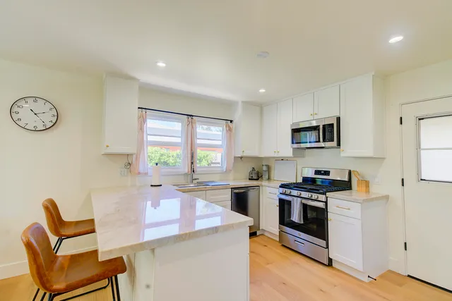 a kitchen with a sink stove and cabinets