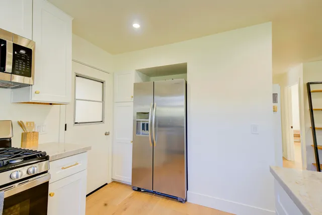 a bathroom with a tub a sink and a mirror
