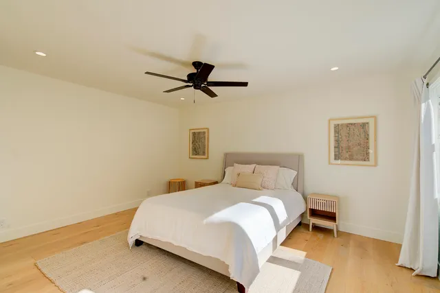 a bedroom with a large bed and a window