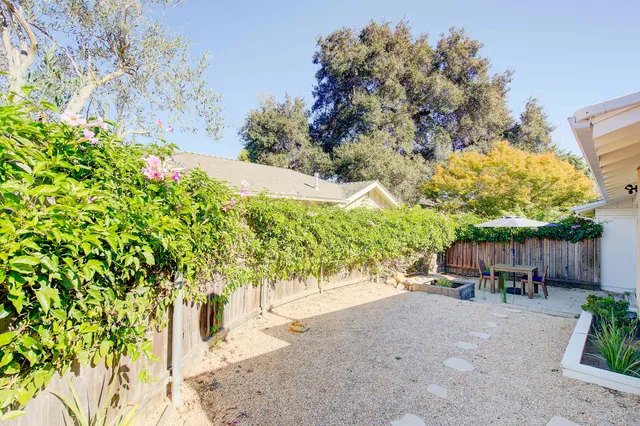 a view of table and chairs under an umbrella