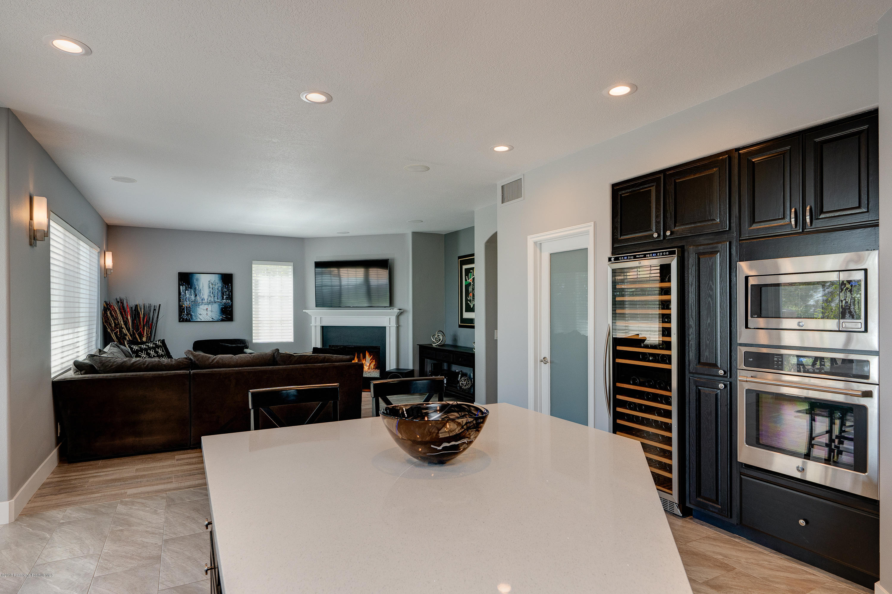 3503 Giddings Ranch Road Altadena, CA 91001 - Photo 18 of 75 a kitchen with stainless steel appliances kitchen island granite countertop a refrigerator oven a sink dishwasher and wooden cabinets with wooden floor