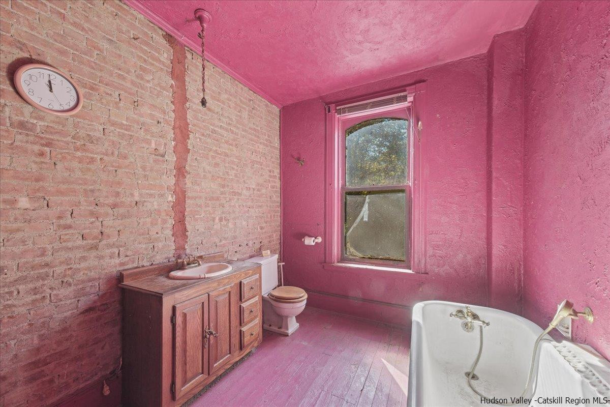 28 Maple Avenue Highland, NY 12528 - Photo 9 of 15 a bathroom with a granite countertop toilet a sink and a window