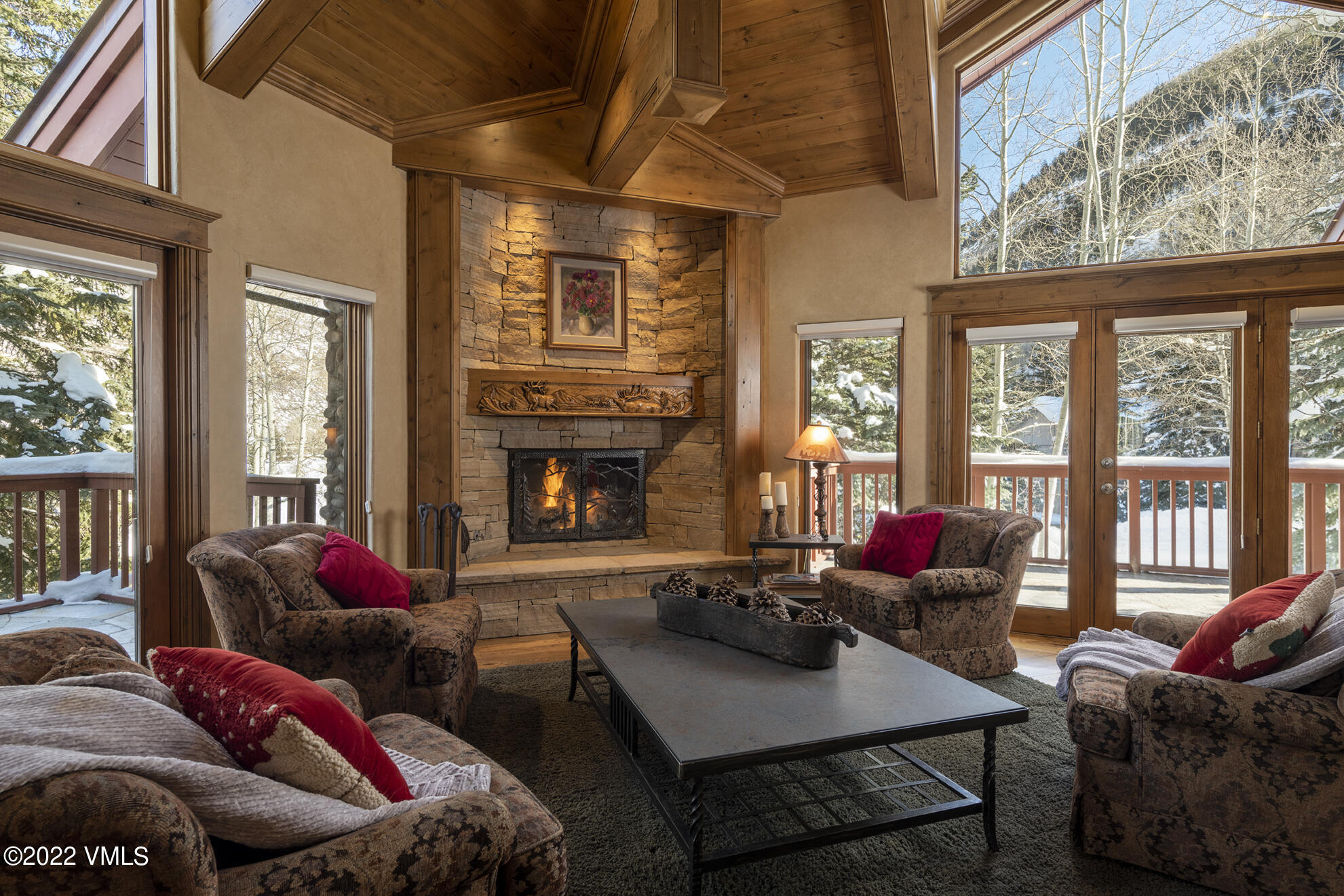 1944 Sunburst Drive, Unit A&B Vail, CO 81657 - Photo 16 of 37 a living room with furniture a fireplace and floor to ceiling windows