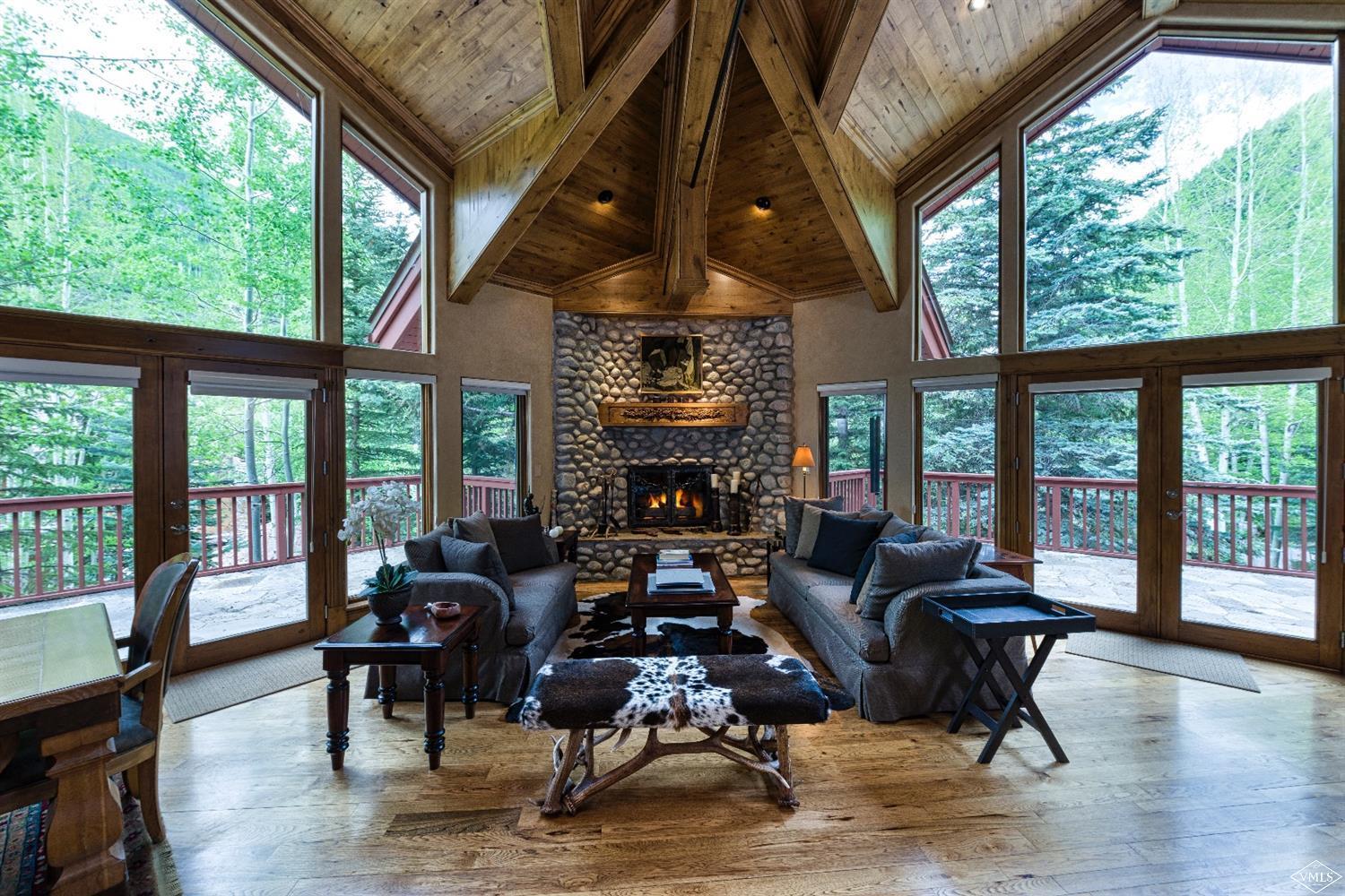 1944 Sunburst Drive, Unit A&B Vail, CO 81657 - Photo 9 of 37 a living room with furniture large windows and wooden floor
