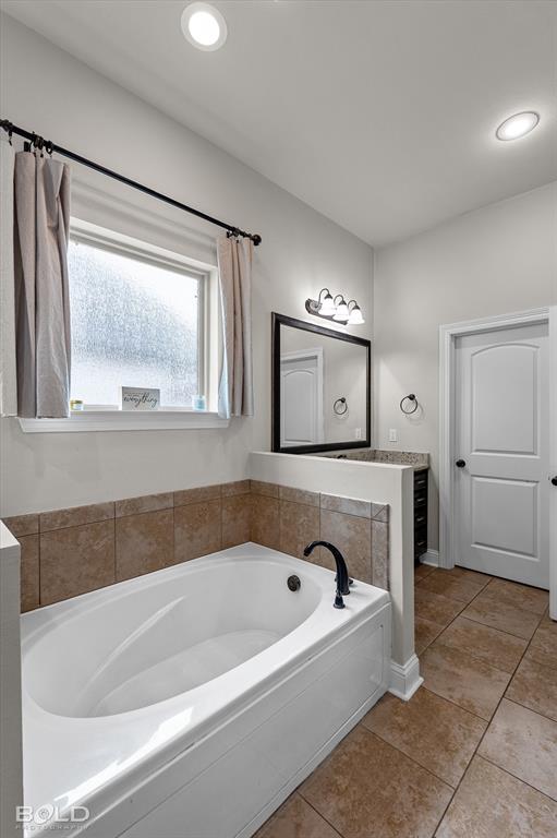 946 Maize Street Bossier City, LA 71111 - Photo 31 of 39 a bathroom with a bathtub and a shower