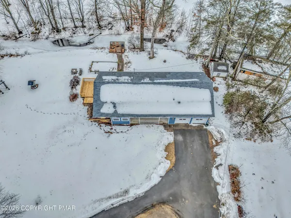 a view of a house with snow on the road