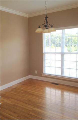 719 Heritage Road Lebanon, TN 37087 - Photo 3 of 6 a view of an empty room with wooden floor and a window