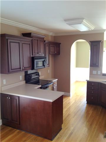 719 Heritage Road Lebanon, TN 37087 - Photo 4 of 6 a kitchen with wooden cabinets and a sink