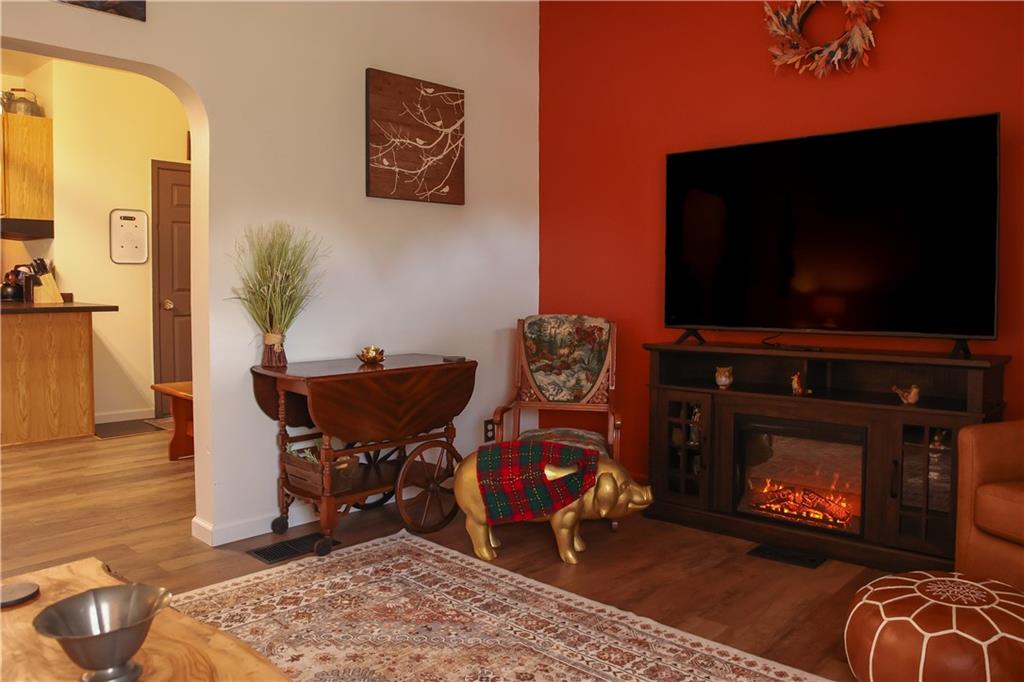 1021 Leesburg Station Road Mercer, PA 16137 - Photo 14 of 45 a living room with furniture a flat screen tv and a fireplace
