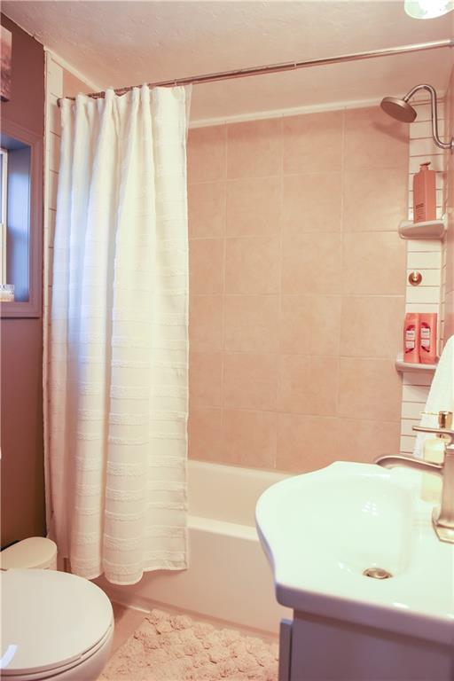 1021 Leesburg Station Road Mercer, PA 16137 - Photo 20 of 45 a bathroom with a sink a toilet and shower curtain