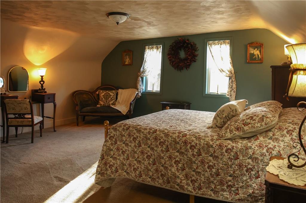 1021 Leesburg Station Road Mercer, PA 16137 - Photo 22 of 45 a bedroom with a bed and a lamp with window