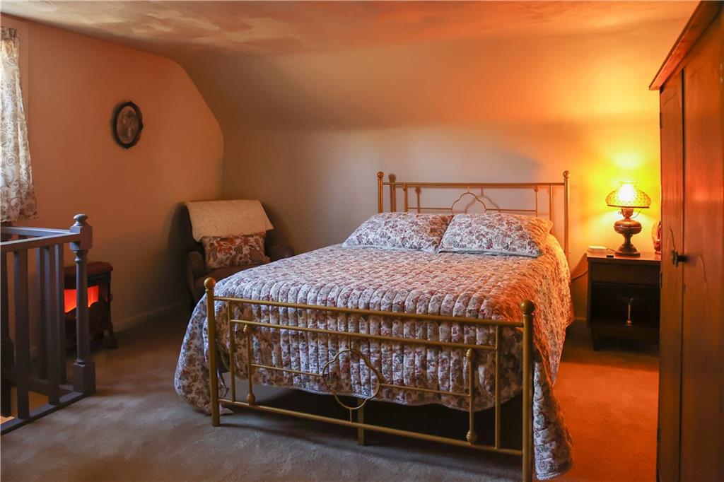 1021 Leesburg Station Road Mercer, PA 16137 - Photo 24 of 45 a bed sitting in a bedroom next to a window