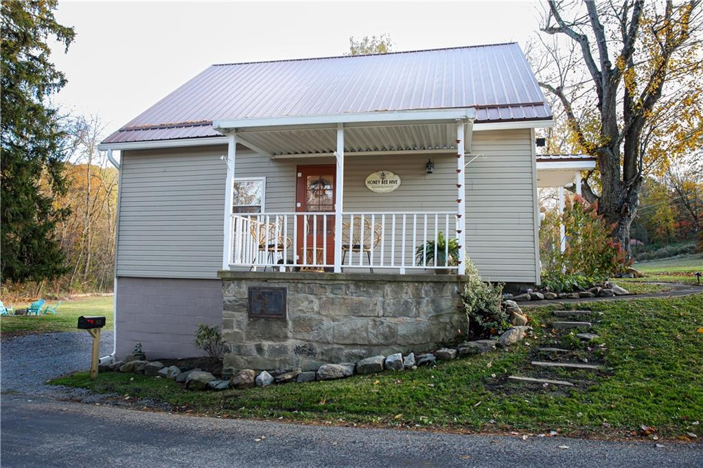 1021 Leesburg Station Road Mercer, PA 16137 - Photo 32 of 45 a front view of a house with garden