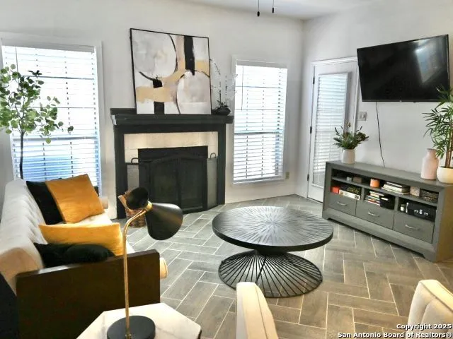 a living room with furniture and a fireplace