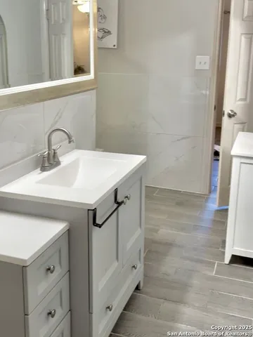 a bathroom with a shower and a sink