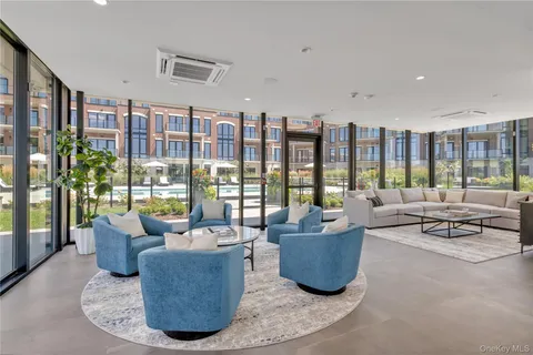 a living room with furniture and a floor to ceiling window