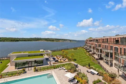 a view of a water with lawn chairs