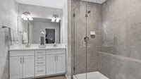 1049 Atterberg Road South Elgin, IL 60177 - Photo 10 of 18 a bathroom with a granite countertop sink a mirror and shower