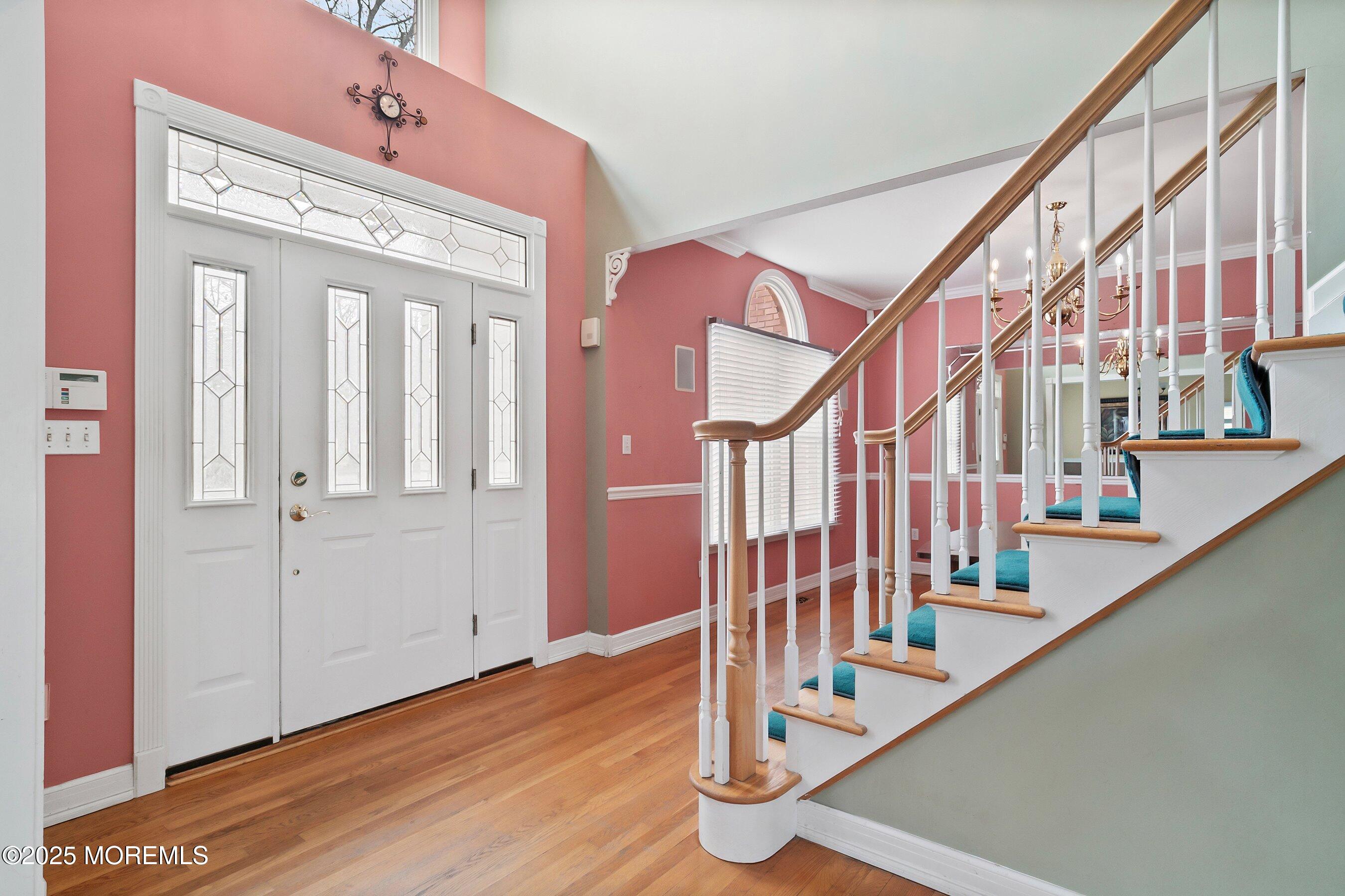 9 Ranch Boulevard Manahawkin, NJ 08050 - Photo 13 of 55 a view of staircase with lots of frames on wall and wooden floor