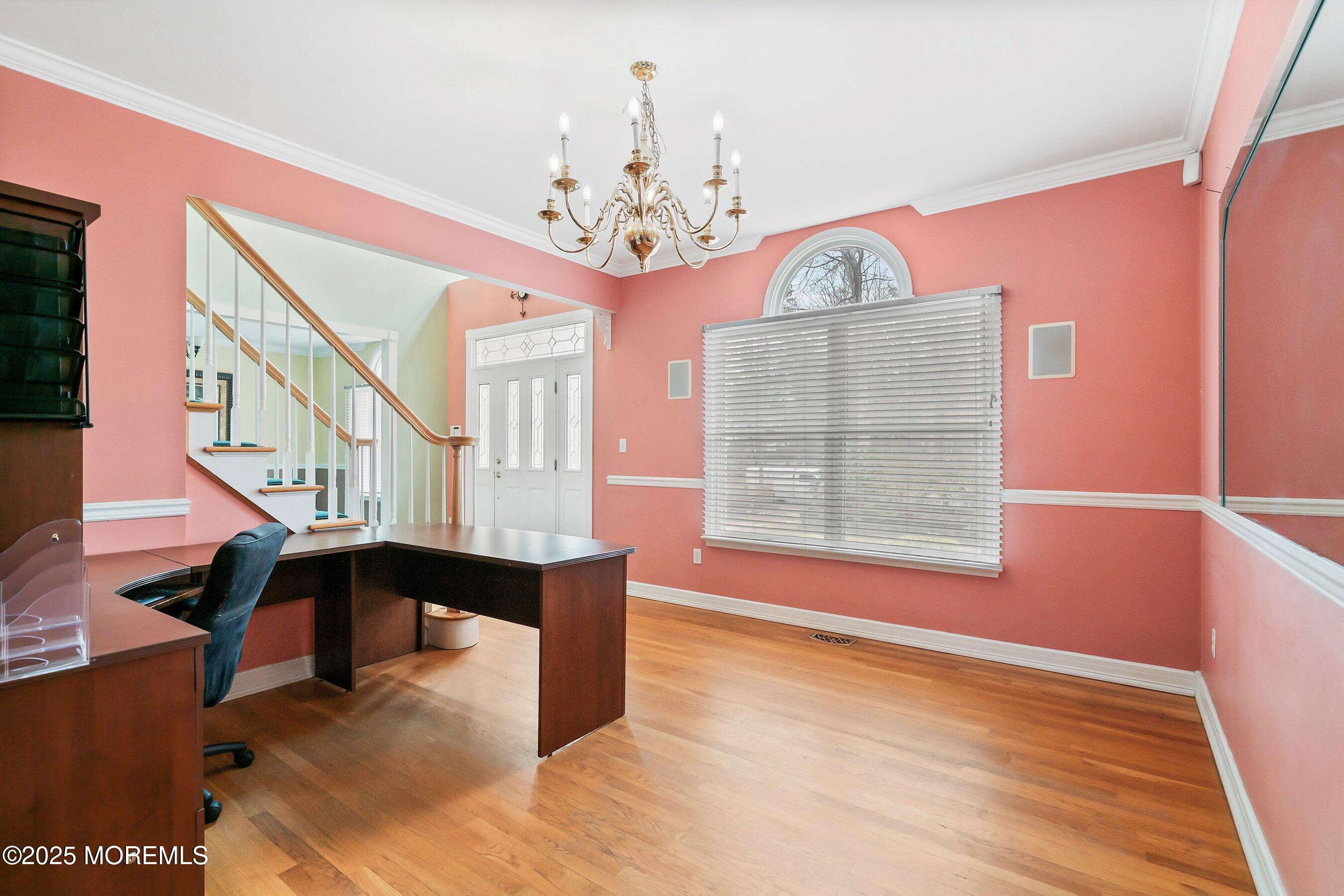 9 Ranch Boulevard Manahawkin, NJ 08050 - Photo 17 of 55 a view of an empty room with chandelier fan and wooden floor