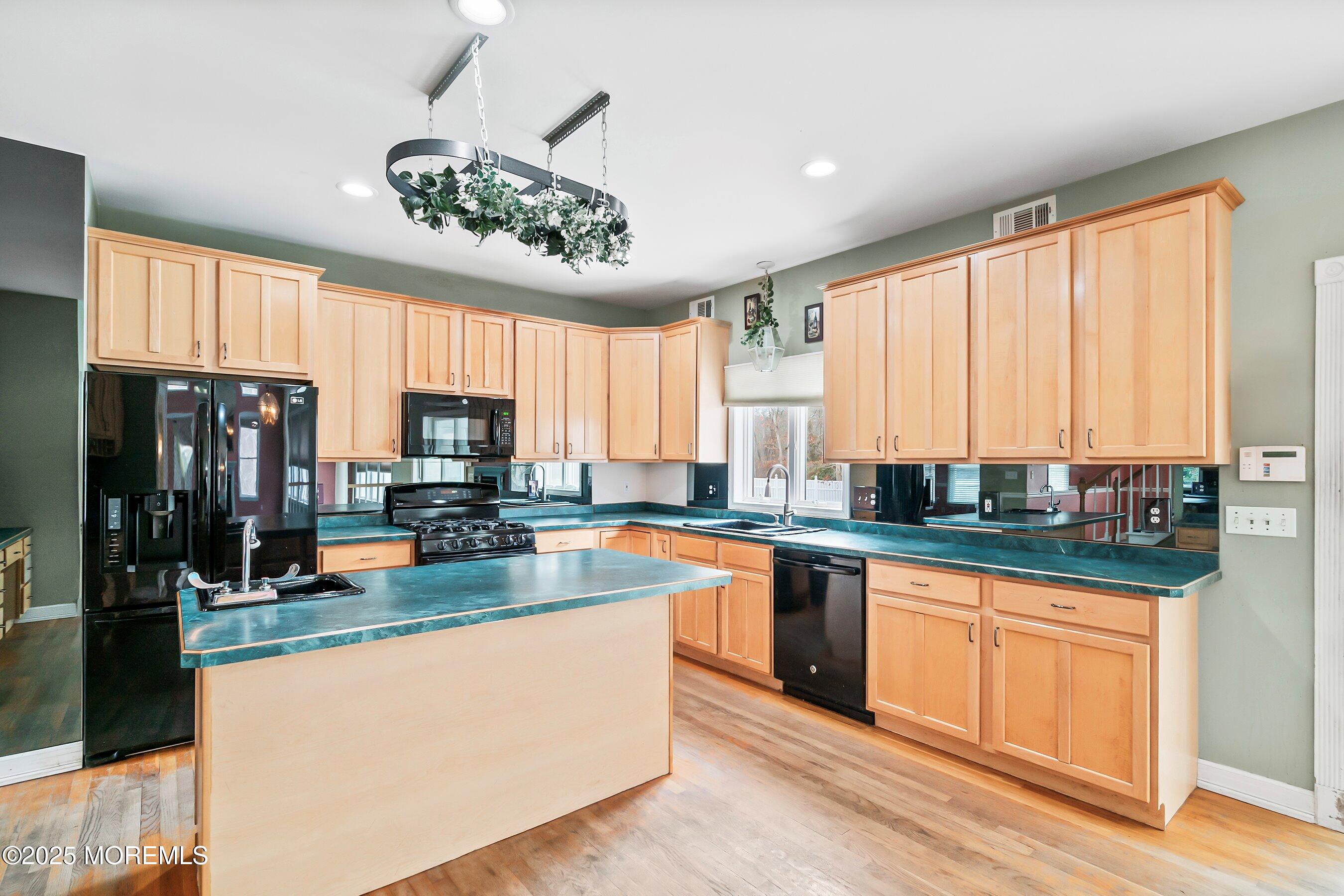 9 Ranch Boulevard Manahawkin, NJ 08050 - Photo 26 of 55 a large kitchen with stainless steel appliances granite countertop a stove a sink and a microwave