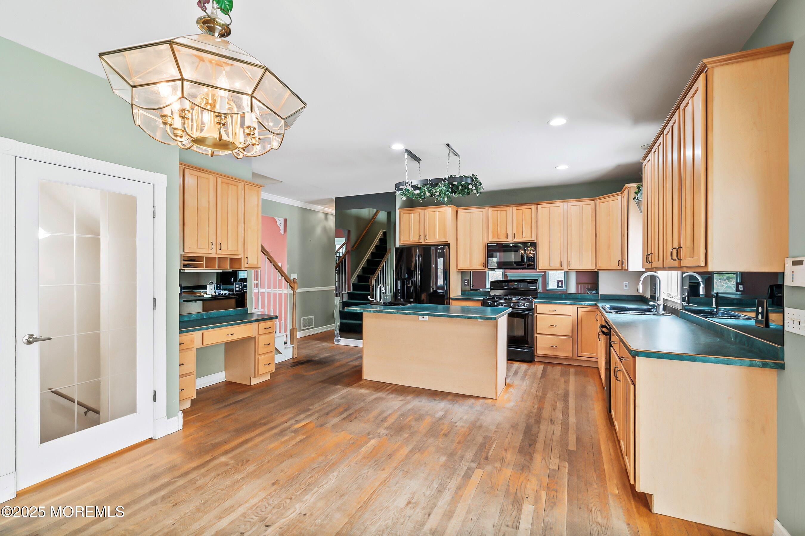 9 Ranch Boulevard Manahawkin, NJ 08050 - Photo 30 of 55 a kitchen with stainless steel appliances granite countertop a refrigerator a sink dishwasher a stove and white countertops with wooden floor