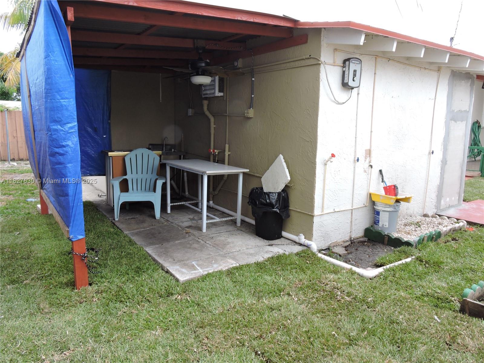 525 East 24th Street, Unit 4 Hialeah, FL 33013 - Photo 4 of 17 a view of a porch with a table and chairs