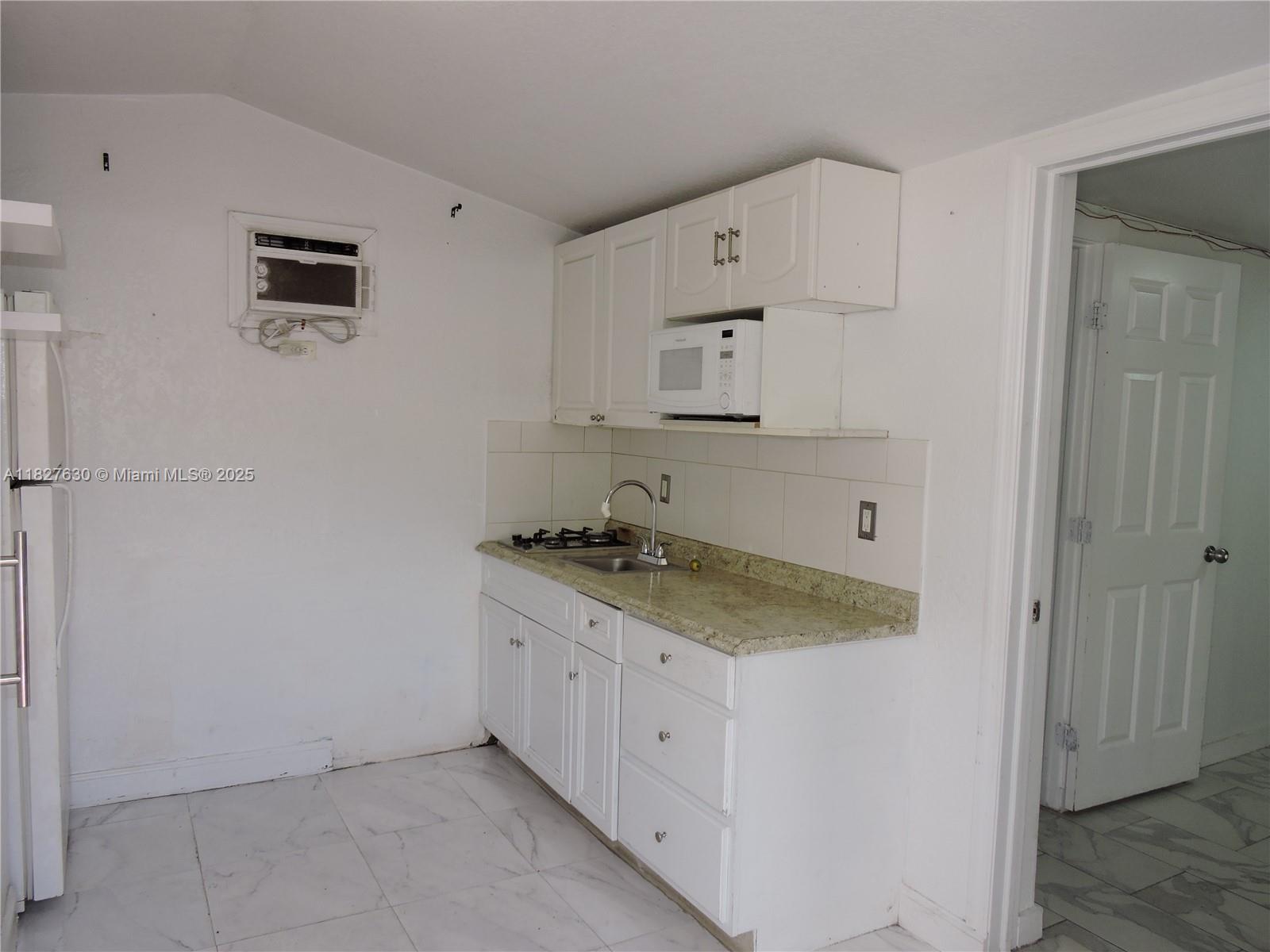525 East 24th Street, Unit 4 Hialeah, FL 33013 - Photo 5 of 17 a utility room with cabinets washer and dryer