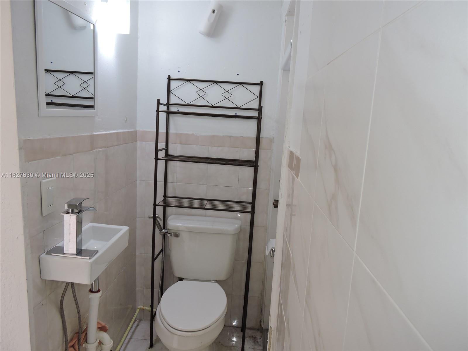 525 East 24th Street, Unit 4 Hialeah, FL 33013 - Photo 6 of 17 a white toilet sitting next to a shower