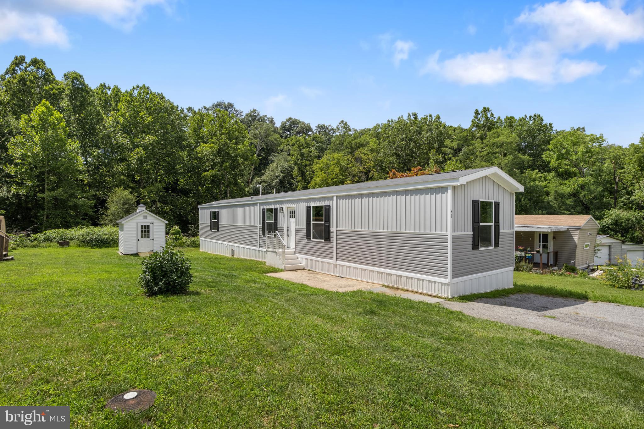31 Mill Street York, PA 17406 - Photo 1 of 19 a front view of house with yard and trees in the background