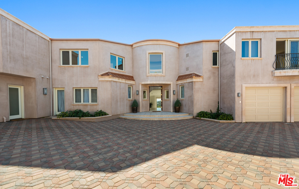 27445 Winding Way Malibu, CA 90265 - Photo 8 of 51 a front view of a house with a yard
