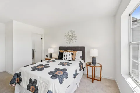 a bedroom with a bed and a window