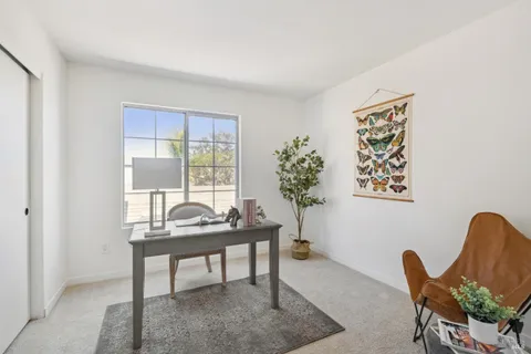 a dining room with furniture and window