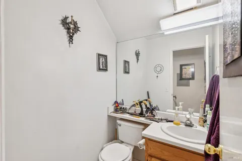 a bathroom with a sink toilet and a mirror