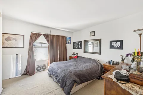 a spacious bedroom with a bed and a window