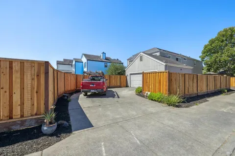 a view of a house with wooden fence