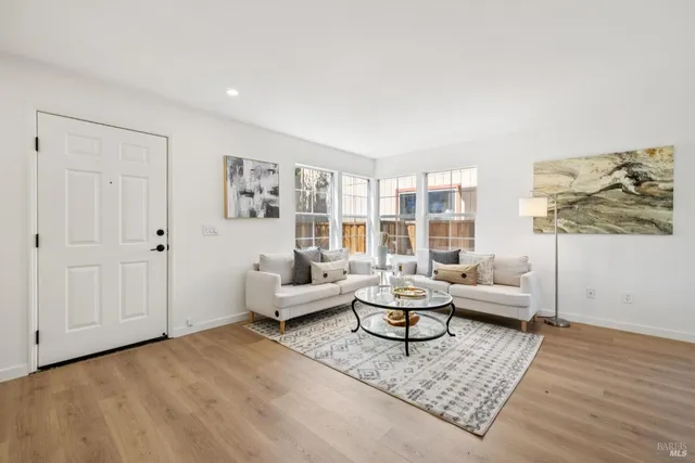 a living room with furniture and wooden floor