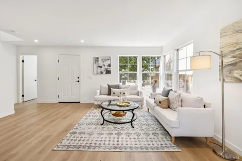 a living room with furniture and a rug