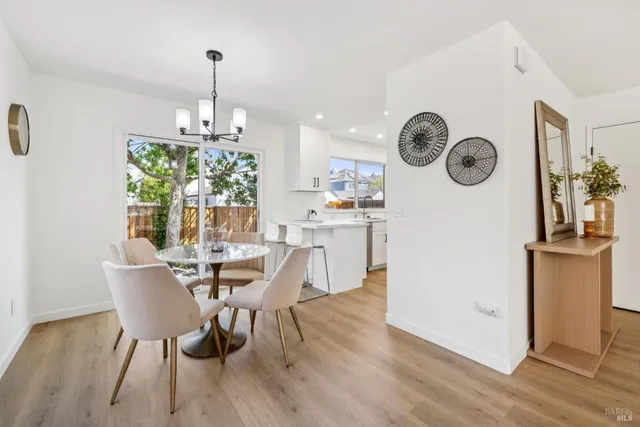 a view of a dining room with furniture wooden floor and chandelier