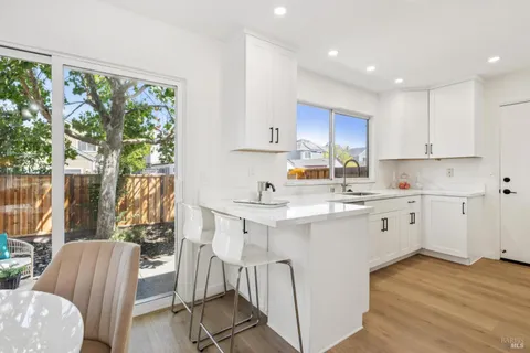 a kitchen with a sink window and cabinets