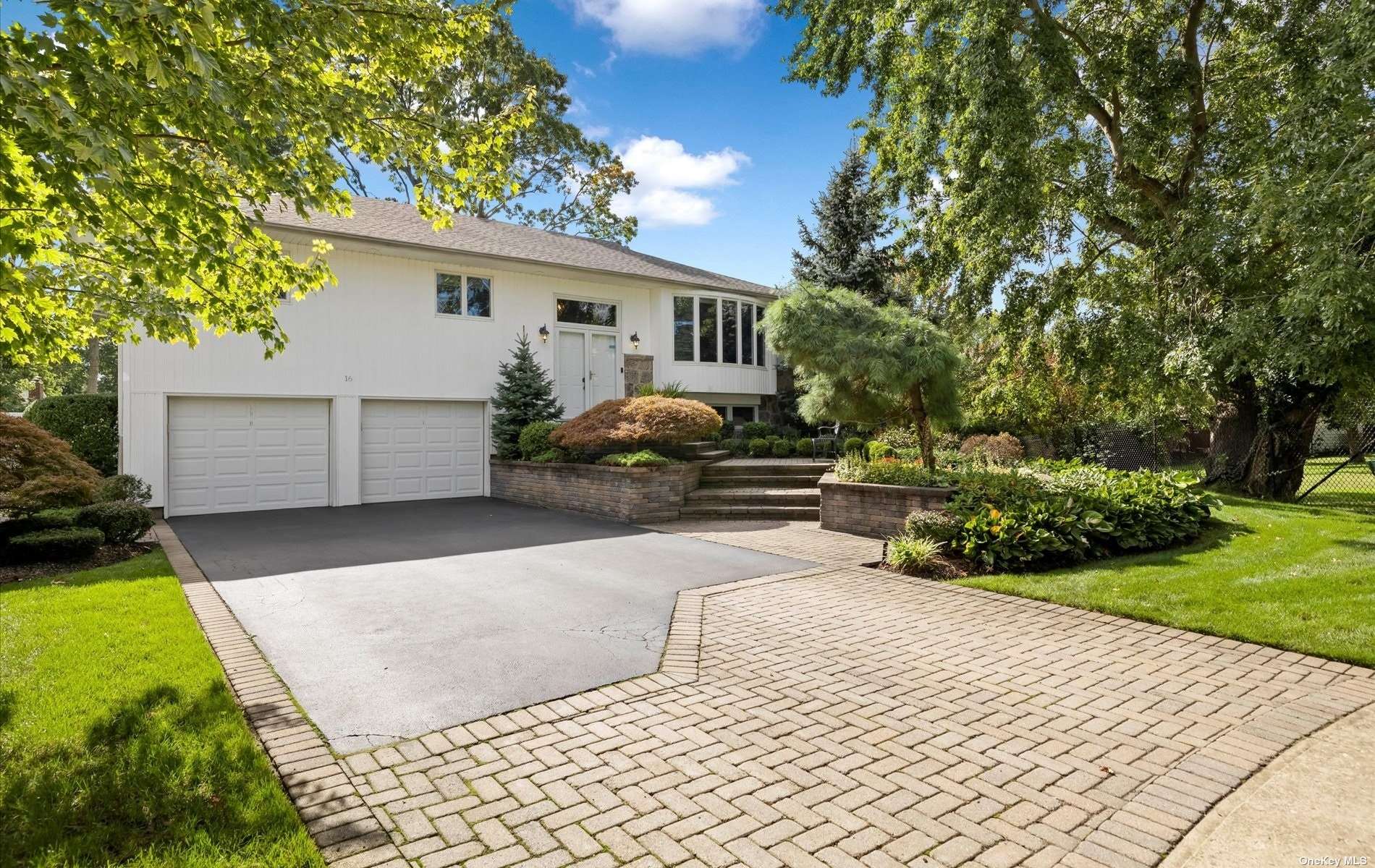 a front view of a house with a yard and a garage