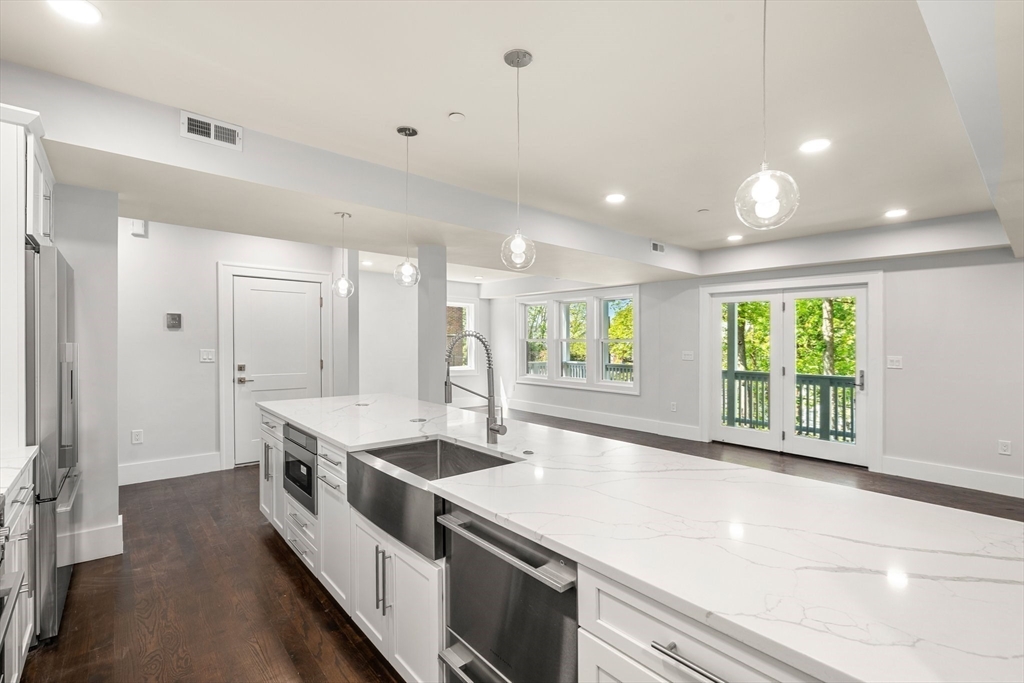 111 Winthrop Road, Unit 2 Brookline, MA 02445 - Photo 3 of 12 a large white kitchen with a large window