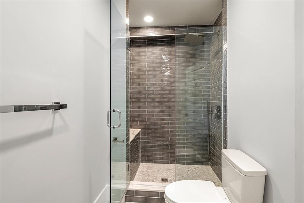 111 Winthrop Road, Unit 2 Brookline, MA 02445 - Photo 7 of 12 a bathroom with a shower and a toilet