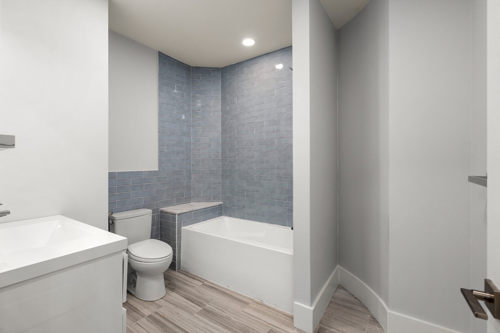 111 Winthrop Road, Unit 2 Brookline, MA 02445 - Photo 8 of 12 a white toilet sitting next to a bathroom sink and vanity