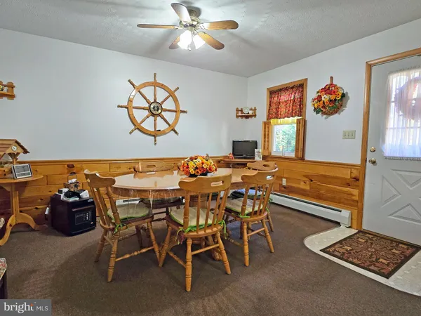 a view of a dining room with furniture and a chandelier