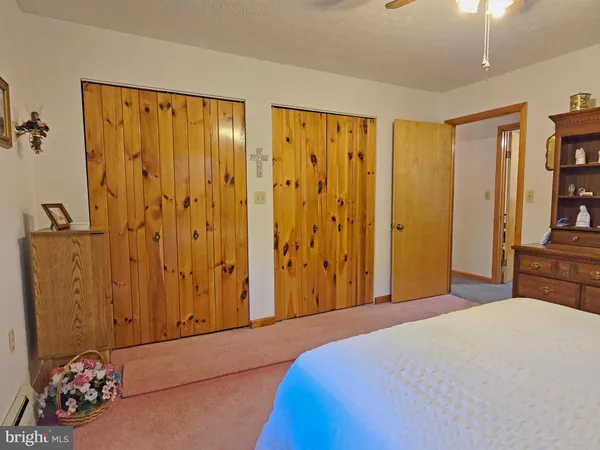 a bedroom with a bed and book shelf
