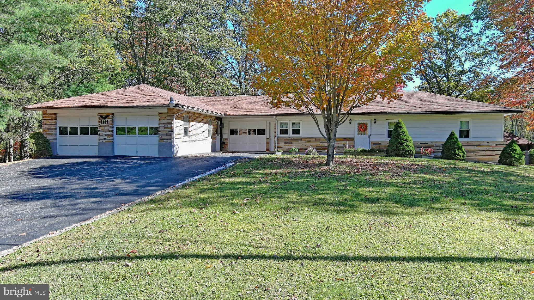 162 Avilton Road Lonaconing, MD 21539 - Photo 2 of 49 a front view of a house with garden