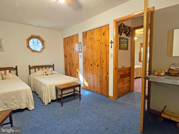 a spacious bedroom with two beds and a dresser