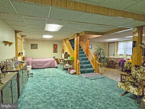 a view of a bedroom with furniture and a gym